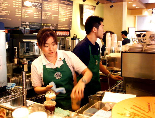 Clerks of a Starbucks Coffee store in Tokyo prepar